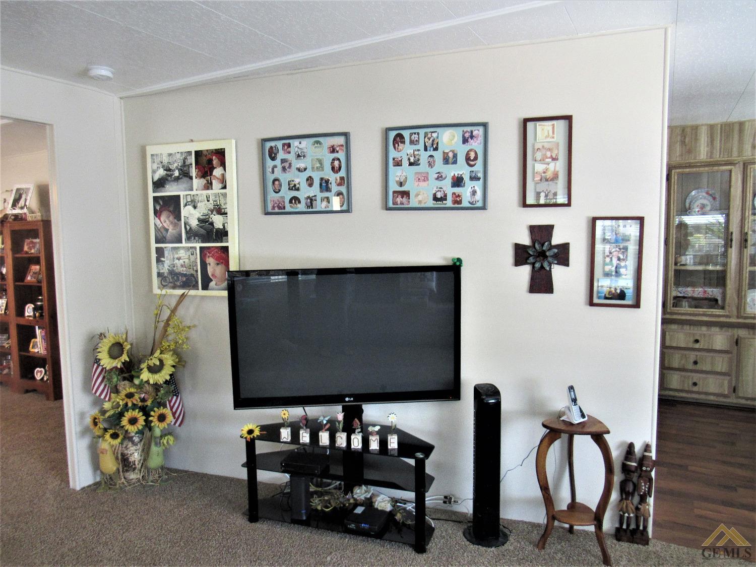 Undisclosed Address Bakersfield, CA 93308 - Photo 6 of 20 a living room with furniture wall paintings and a flat screen tv