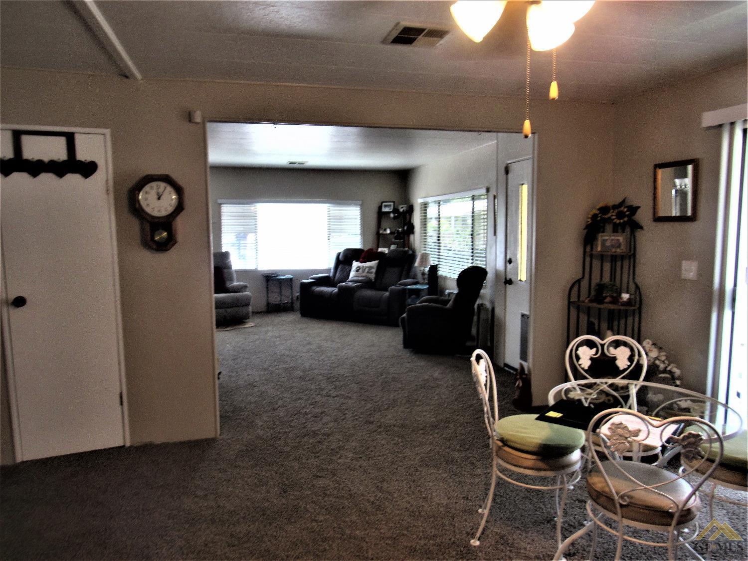 Undisclosed Address Bakersfield, CA 93308 - Photo 7 of 20 a living room with furniture and a large window
