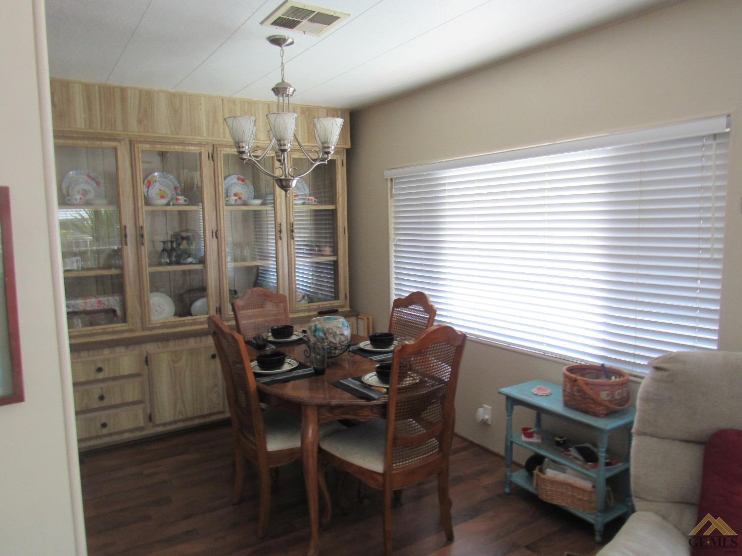 Undisclosed Address Bakersfield, CA 93308 - Photo 8 of 20 a dining room with furniture a chandelier and wooden floor