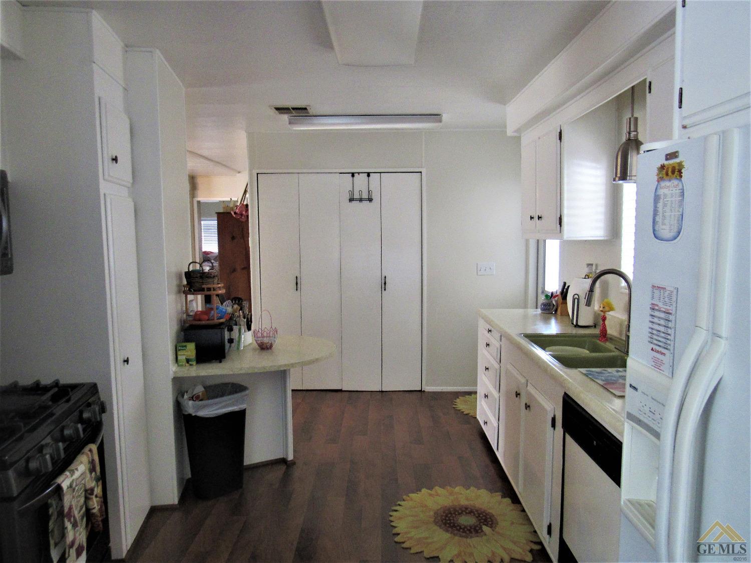 Undisclosed Address Bakersfield, CA 93308 - Photo 10 of 20 a kitchen with stainless steel appliances granite countertop a sink stove and cabinets