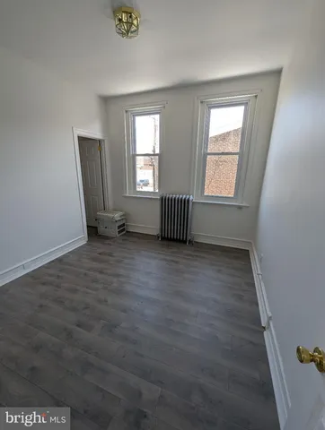 a view of an empty room and a window