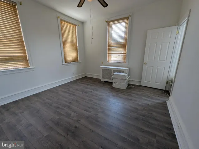 a view of wooden floor and windows in a room
