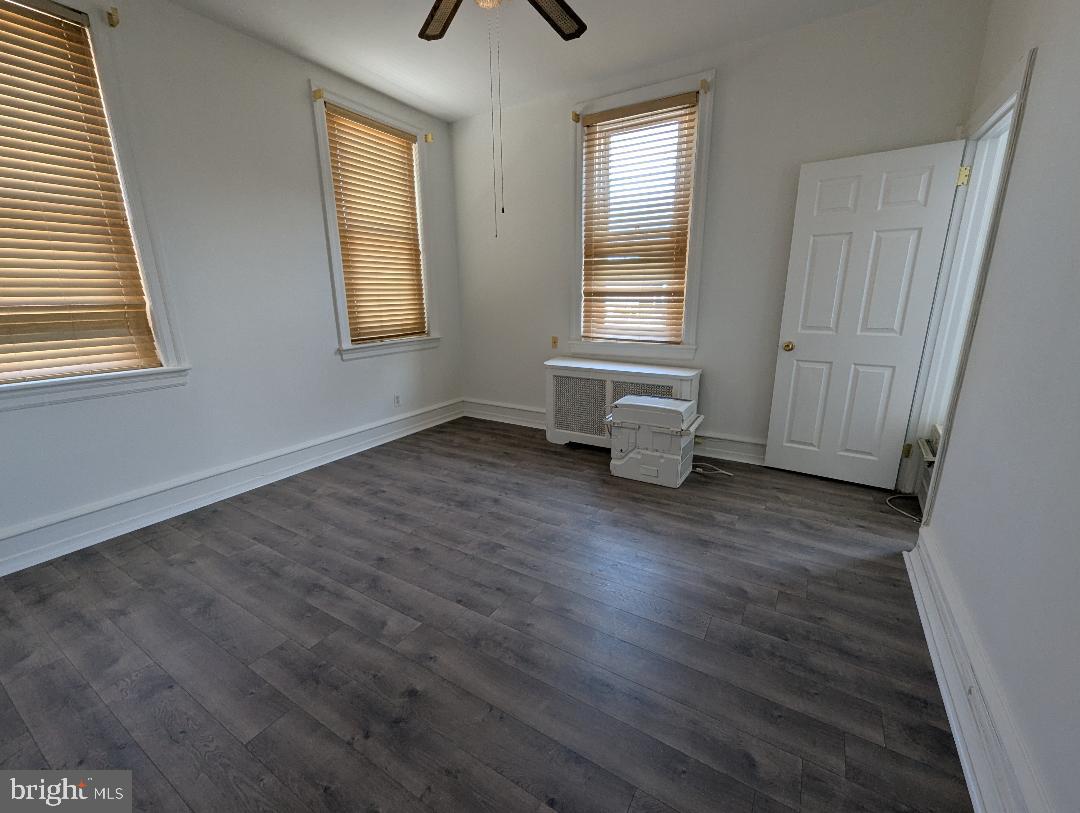 7158 Torresdale Avenue Philadelphia, PA 19135 - Photo 16 of 17 a view of empty room with wooden floor and fan