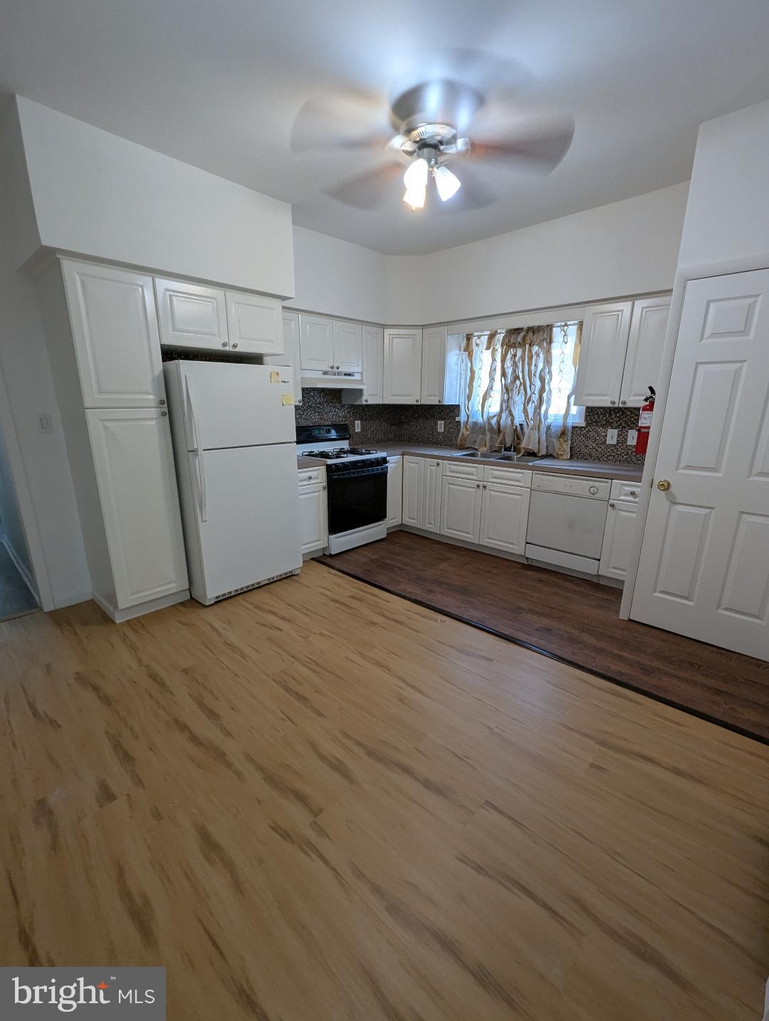 7158 Torresdale Avenue Philadelphia, PA 19135 - Photo 5 of 17 a kitchen with stainless steel appliances a refrigerator and a stove