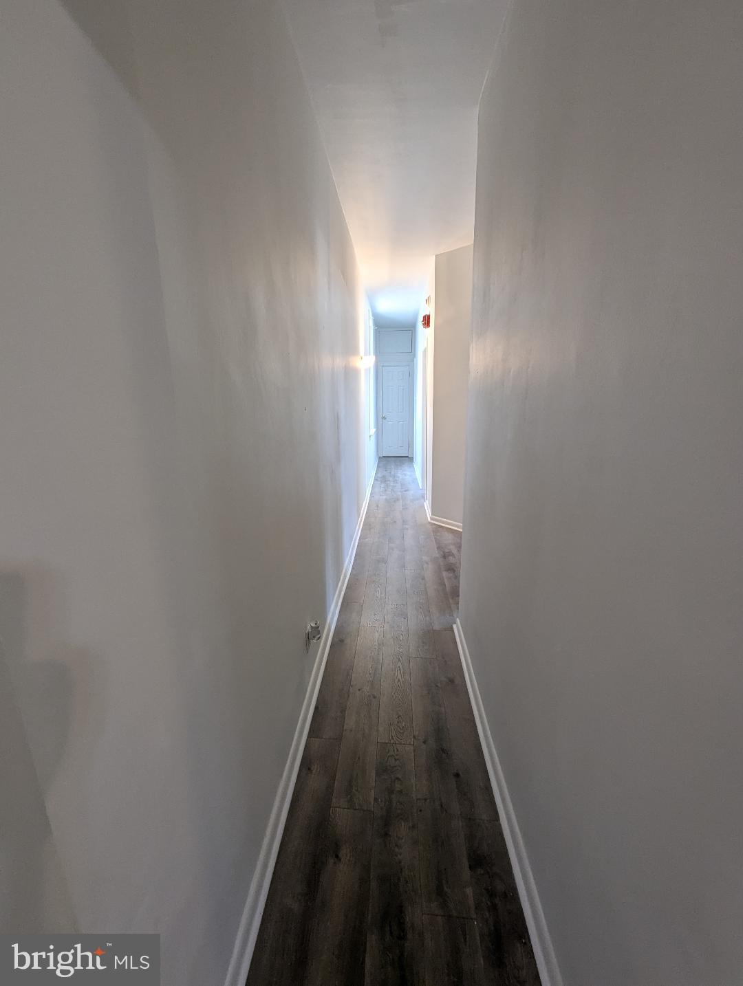 7158 Torresdale Avenue Philadelphia, PA 19135 - Photo 8 of 17 a view of a hallway with wooden floor