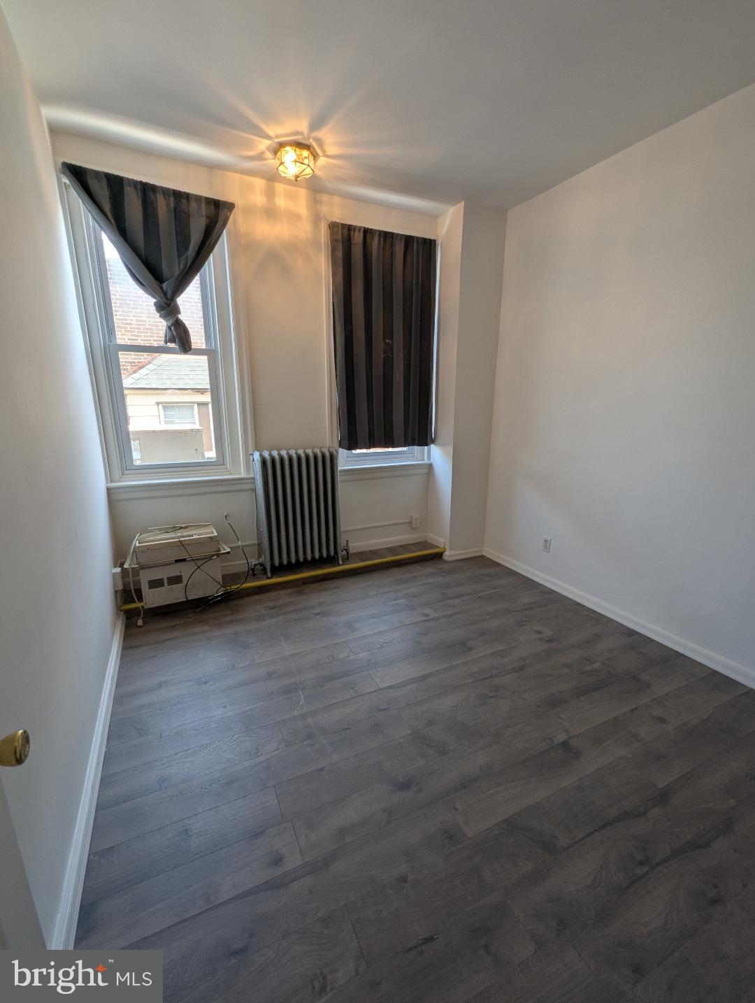 7158 Torresdale Avenue Philadelphia, PA 19135 - Photo 9 of 17 a view of room with window and hardwood floor