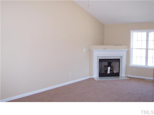 340 Ridge Road Angier, NC 27501 - Photo 3 of 7 Large family room with a cathedral ceiling and a cozy gas log fireplace.
