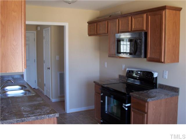 340 Ridge Road Angier, NC 27501 - Photo 4 of 7 Kitchen with nice cabinets and a built-in microwave.