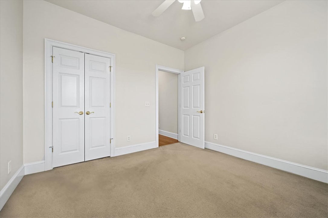 38 Angus Run Seneca, SC 29672 - Photo 23 of 46 This spacious bedroom offers ample natural light, soft carpet, and convenient closet storage.