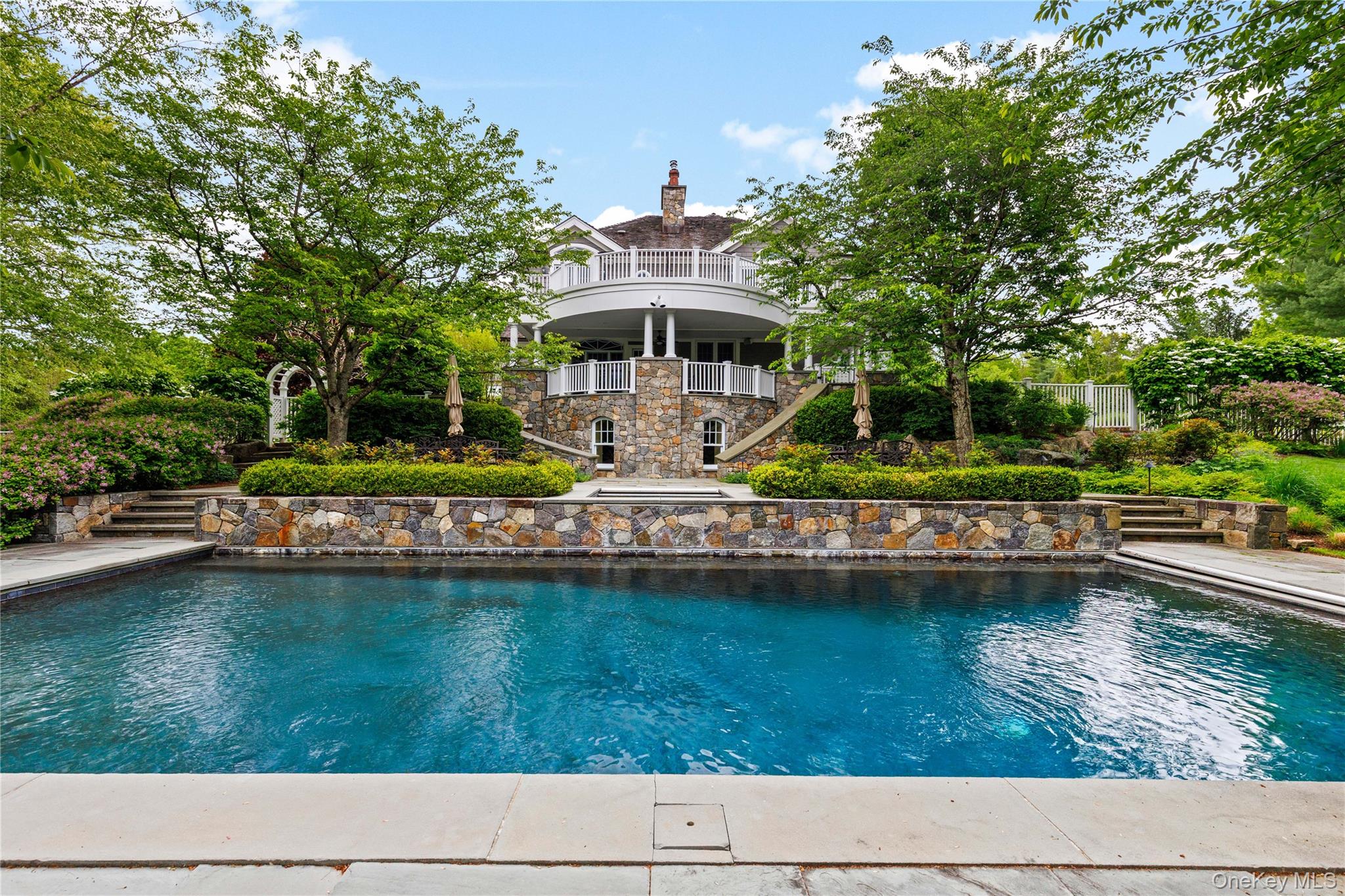 63 Old Mill River Road Pound Ridge, NY 10576 - Photo 3 of 47 a house view with a swimming pool and sitting space