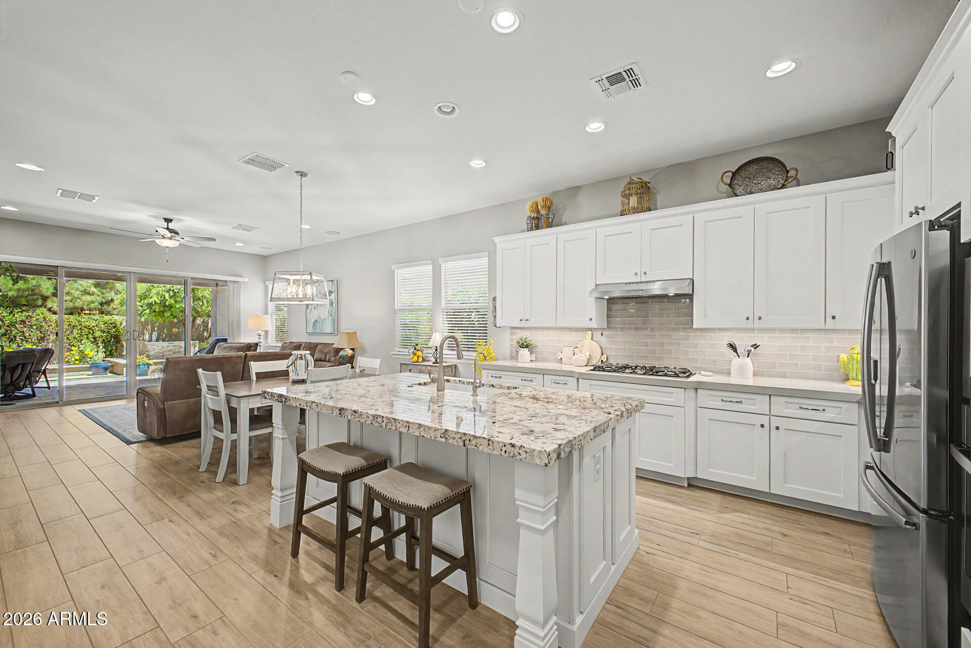 3560 East Appaloosa Road Gilbert, AZ 85296 - Photo 12 of 32 a kitchen with appliances a sink a counter top space and living room view