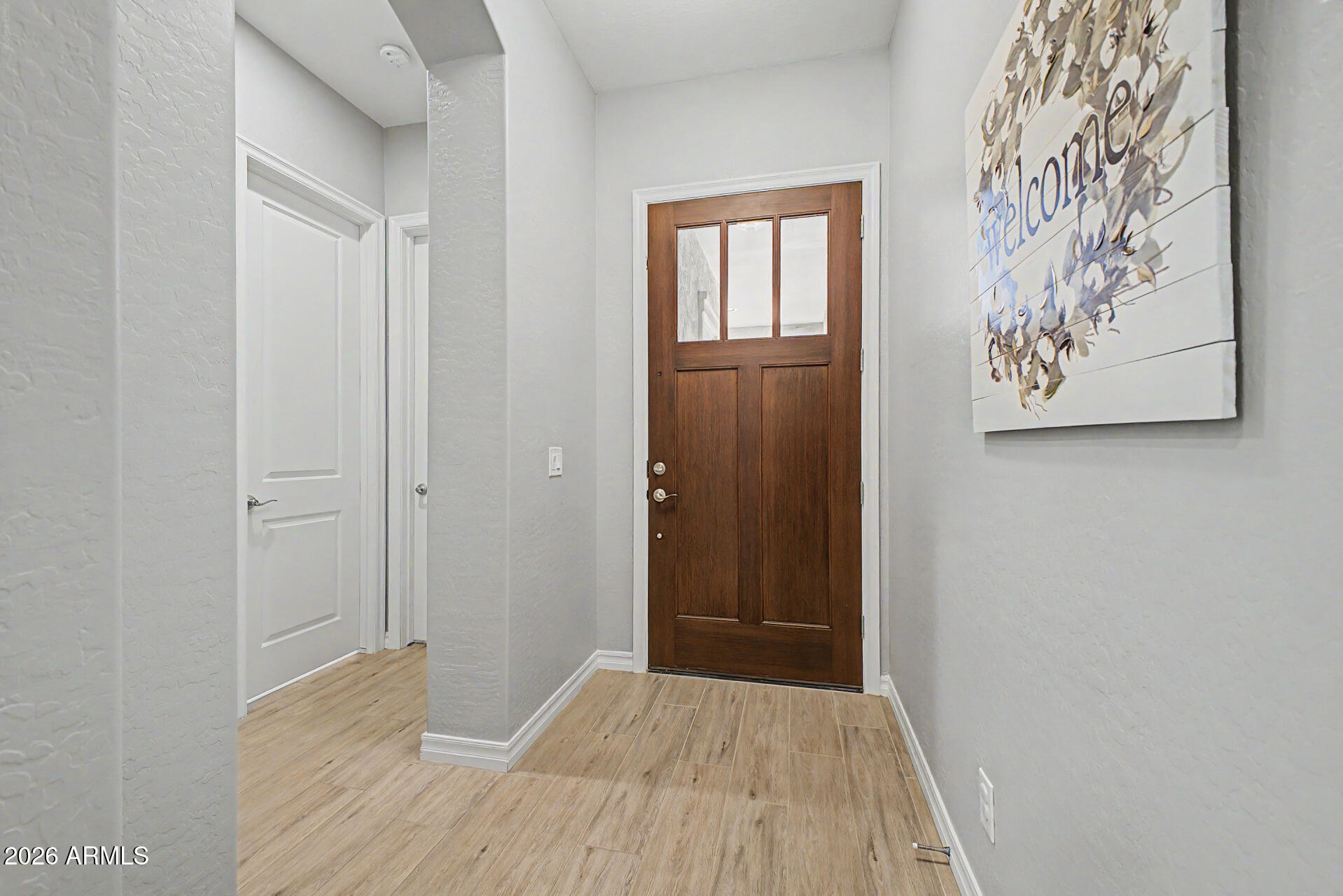 3560 East Appaloosa Road Gilbert, AZ 85296 - Photo 2 of 32 a view of a hallway with wooden floor and closet