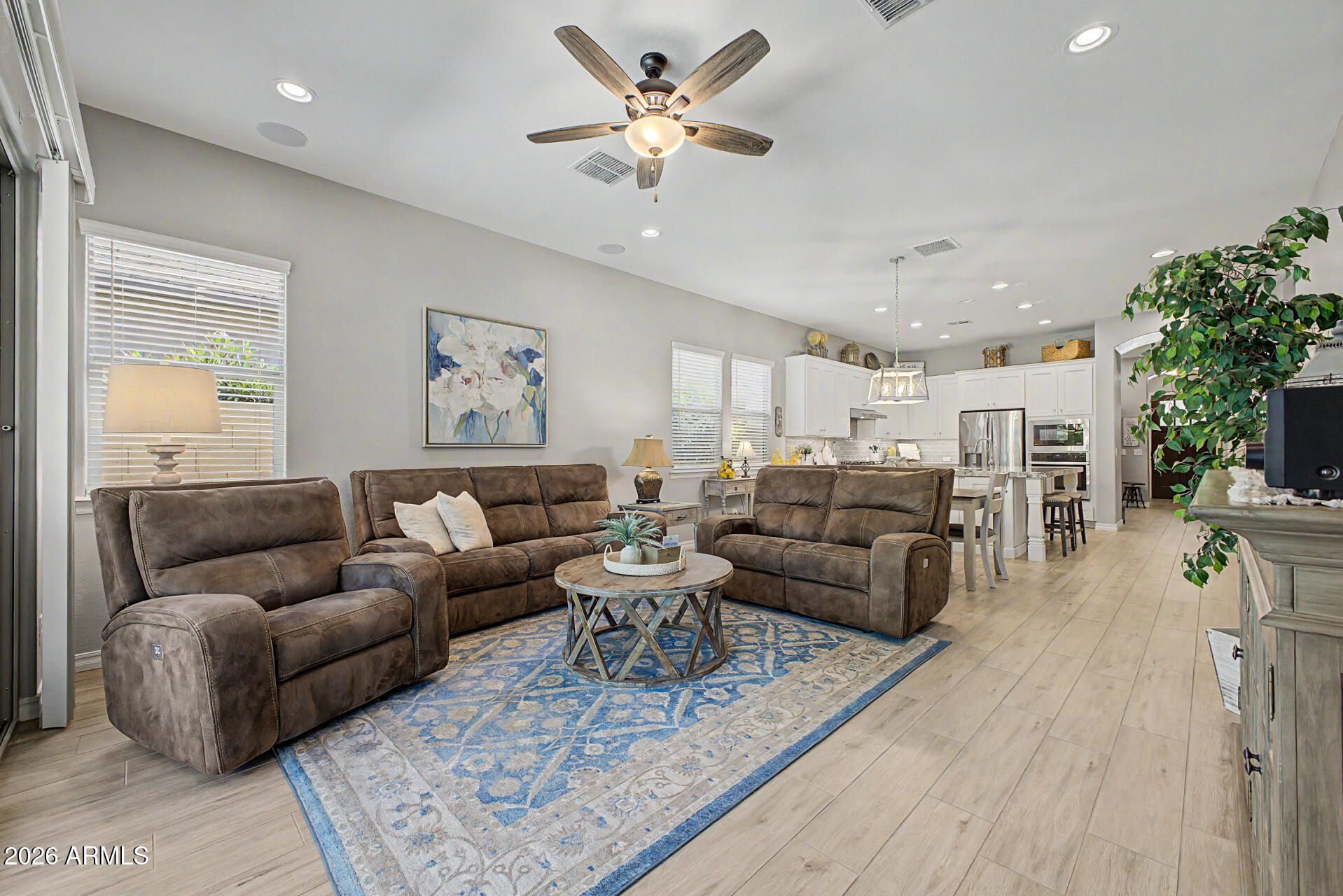 3560 East Appaloosa Road Gilbert, AZ 85296 - Photo 7 of 32 a living room with furniture ceiling fan and a rug