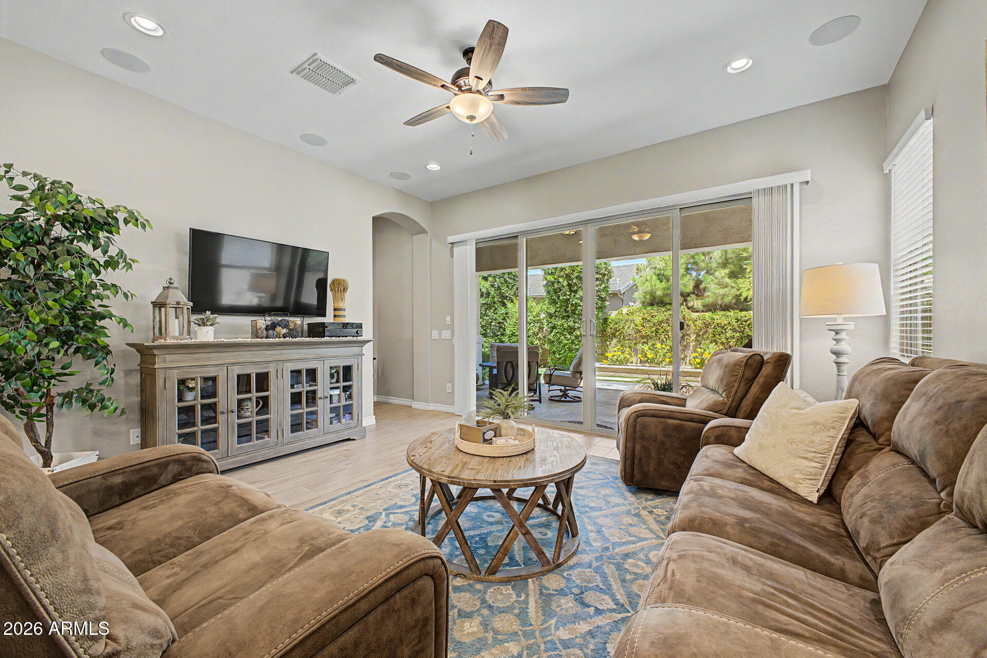 3560 East Appaloosa Road Gilbert, AZ 85296 - Photo 8 of 32 a living room with furniture a fireplace and a flat screen tv