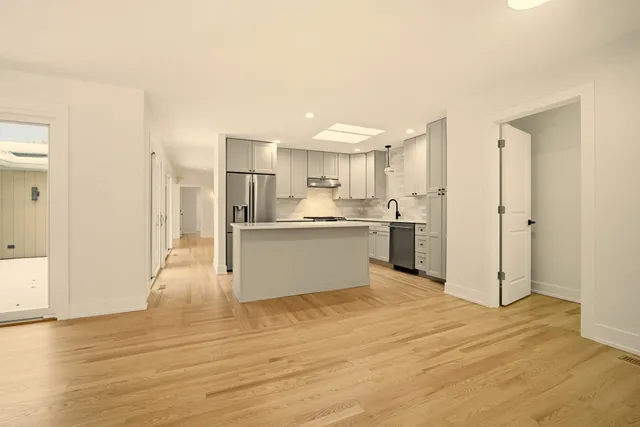 a view of a kitchen with wooden floor