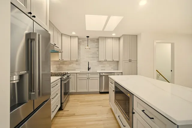 a kitchen with a sink stove and refrigerator