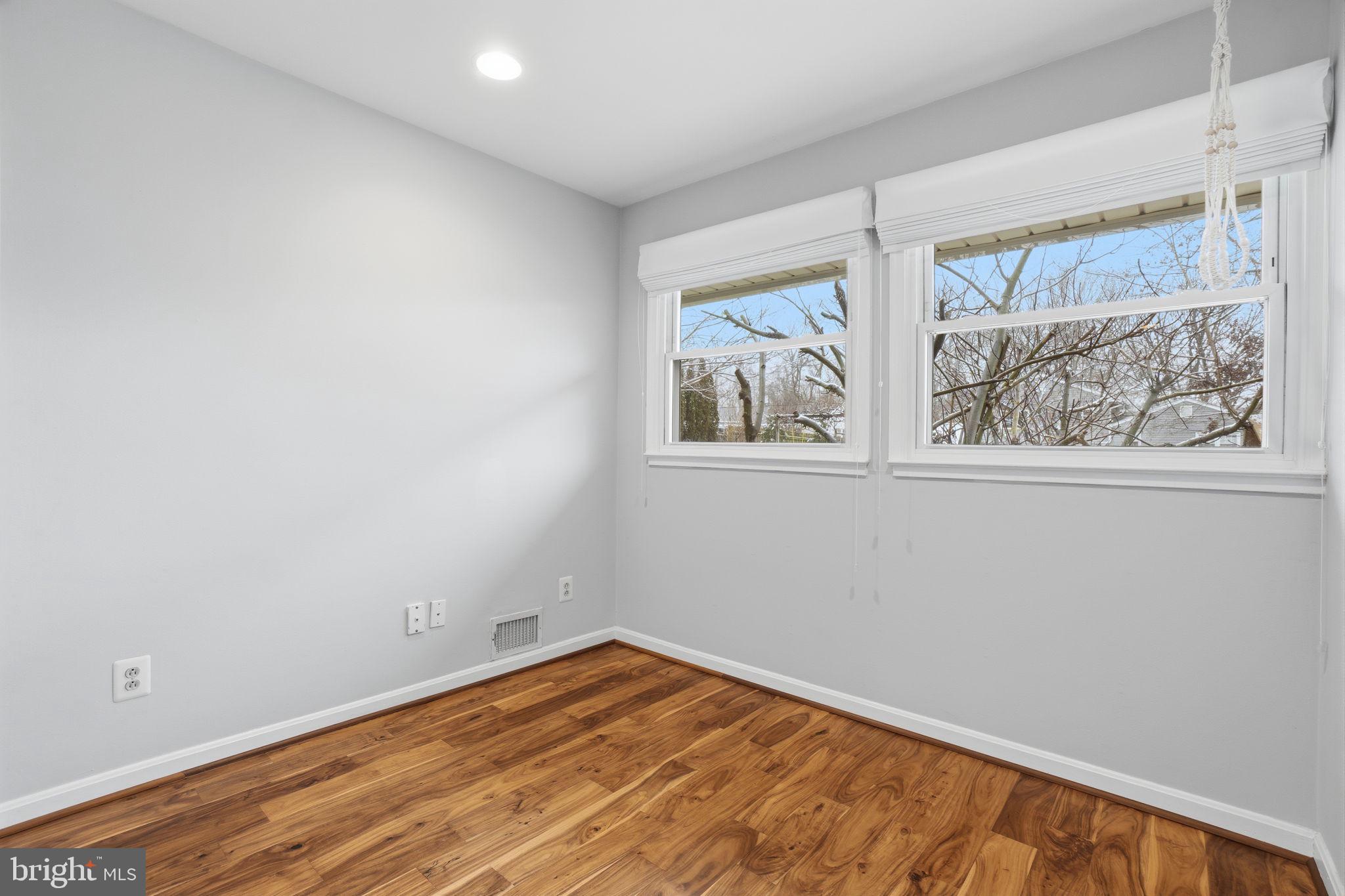 7921 Foote Lane Springfield, VA 22151 - Photo 11 of 26 a view of empty room with wooden floor and fan