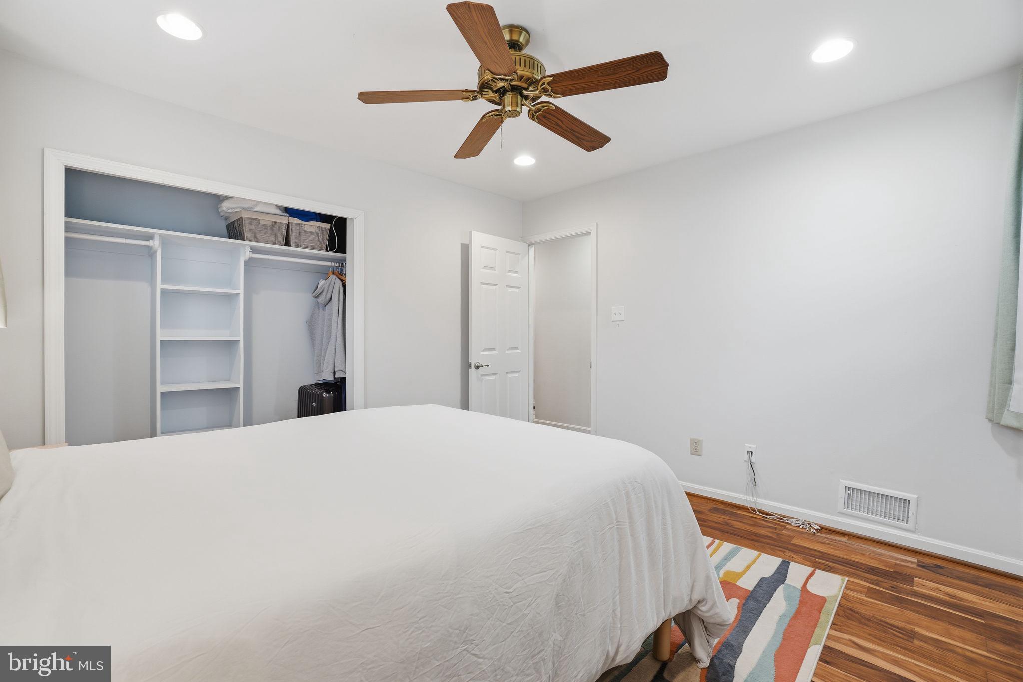 7921 Foote Lane Springfield, VA 22151 - Photo 14 of 26 a bedroom with a bed and a chandelier