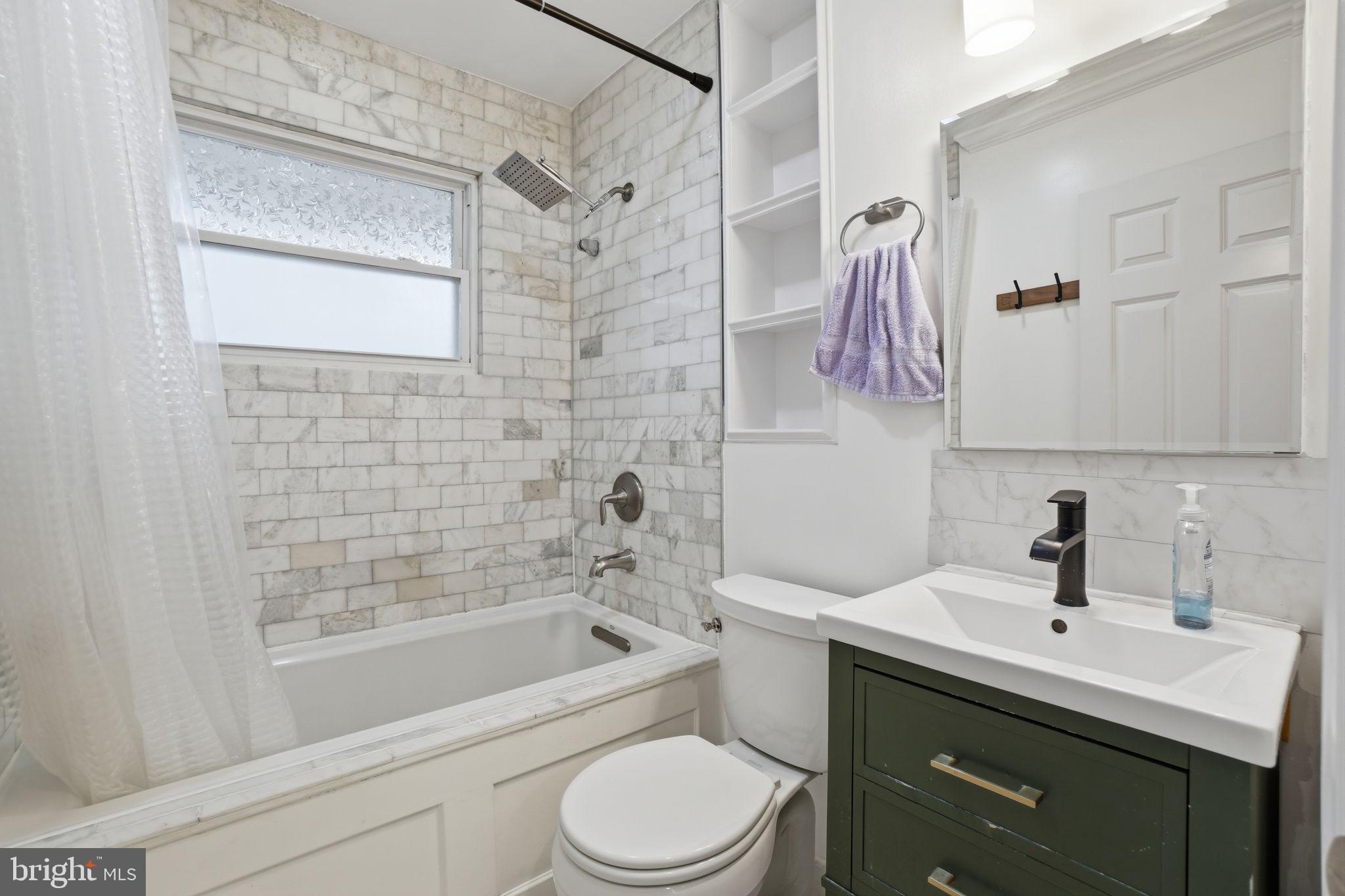 7921 Foote Lane Springfield, VA 22151 - Photo 15 of 26 a bathroom with a sink toilet vanity and shower