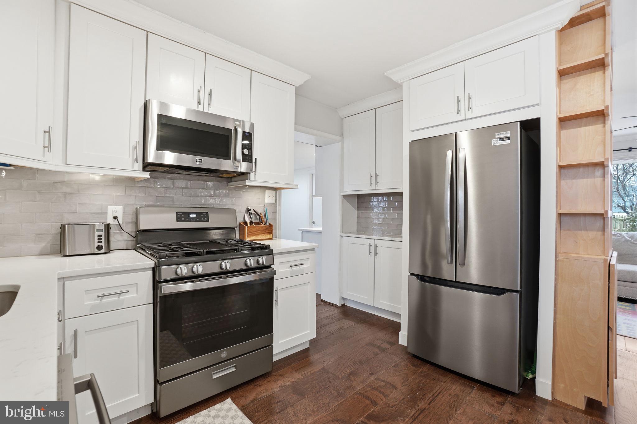 7921 Foote Lane Springfield, VA 22151 - Photo 3 of 26 a kitchen with stainless steel appliances a refrigerator stove and microwave