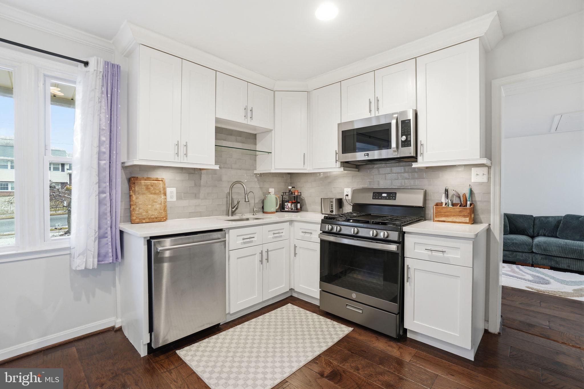 7921 Foote Lane Springfield, VA 22151 - Photo 4 of 26 a kitchen with stainless steel appliances granite countertop a stove a sink and a microwave
