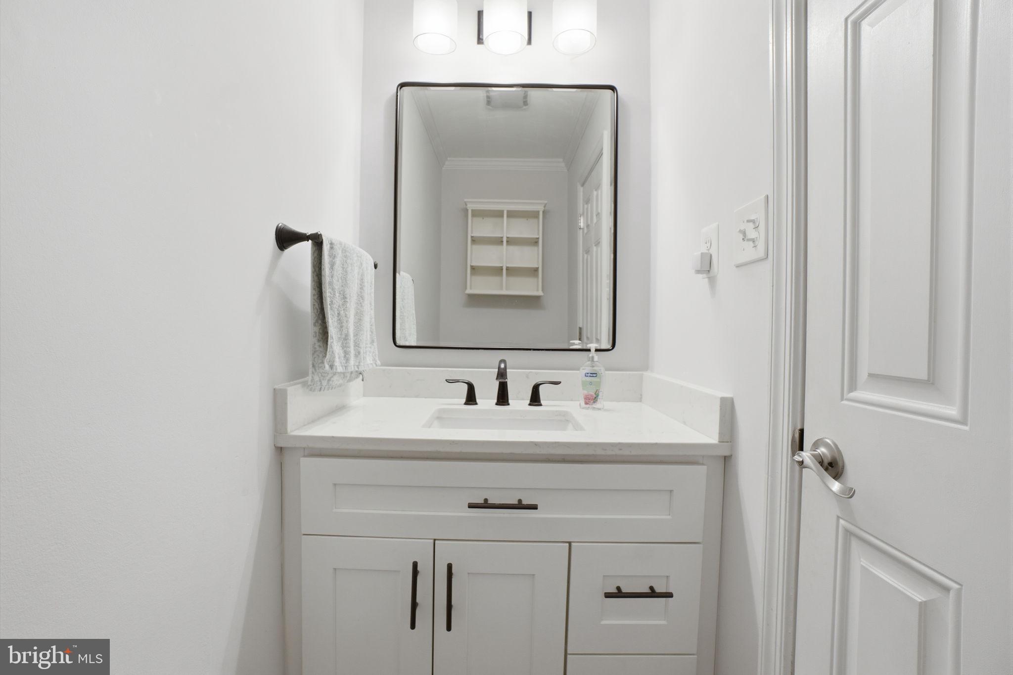 7921 Foote Lane Springfield, VA 22151 - Photo 8 of 26 a bathroom with a sink and a mirror