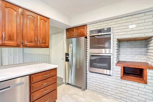 a kitchen with stainless steel appliances granite countertop a refrigerator and a stove