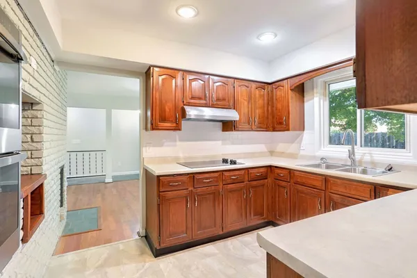 a kitchen with a sink stove and cabinets