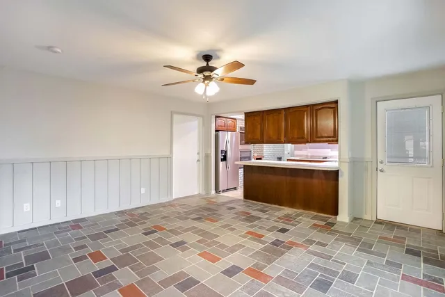 a view of a kitchen with wooden floor and a kitchen
