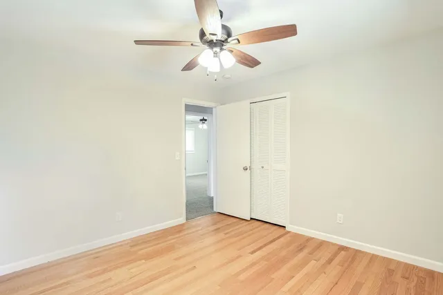 a view of an empty room with wooden floor