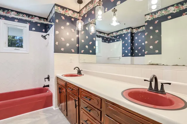 a bathroom with a sink a tub and a mirror