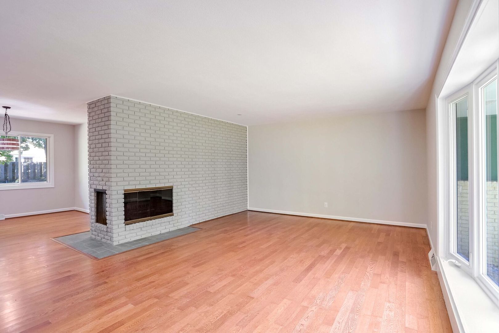 1716 Georgetown Drive Champaign, IL 61821 - Photo 7 of 36 a view of empty room with wooden floor and fireplace