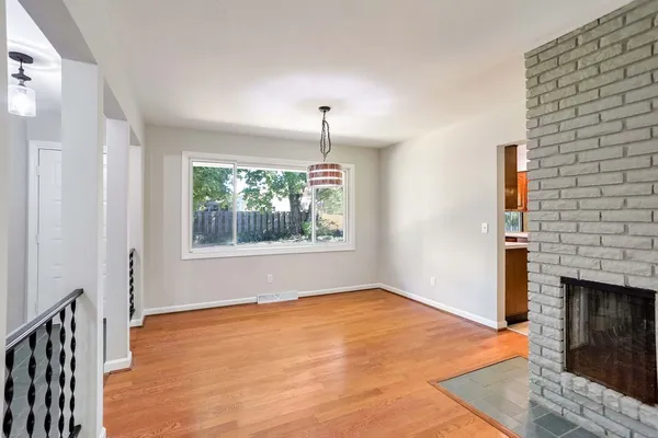 a big room with windows and a fireplace
