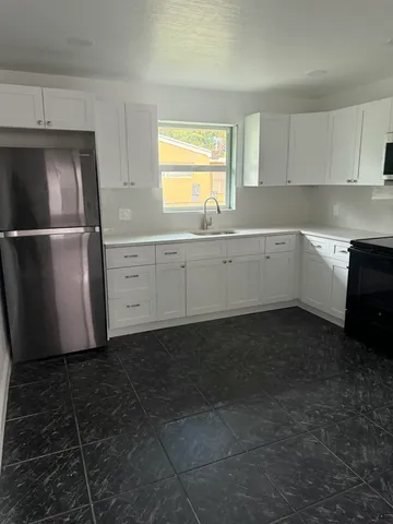 a kitchen with a refrigerator and window