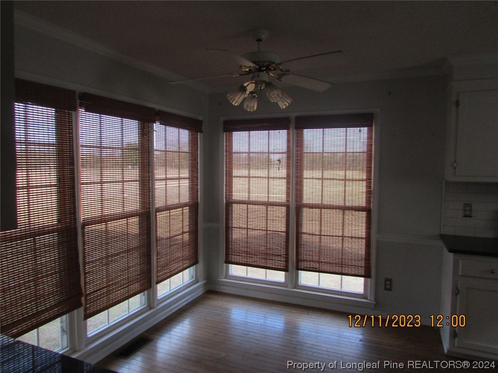 8850 Timothy Road Dunn, NC 28334 - Photo 12 of 15 a view of an empty room with wooden floor and a window
