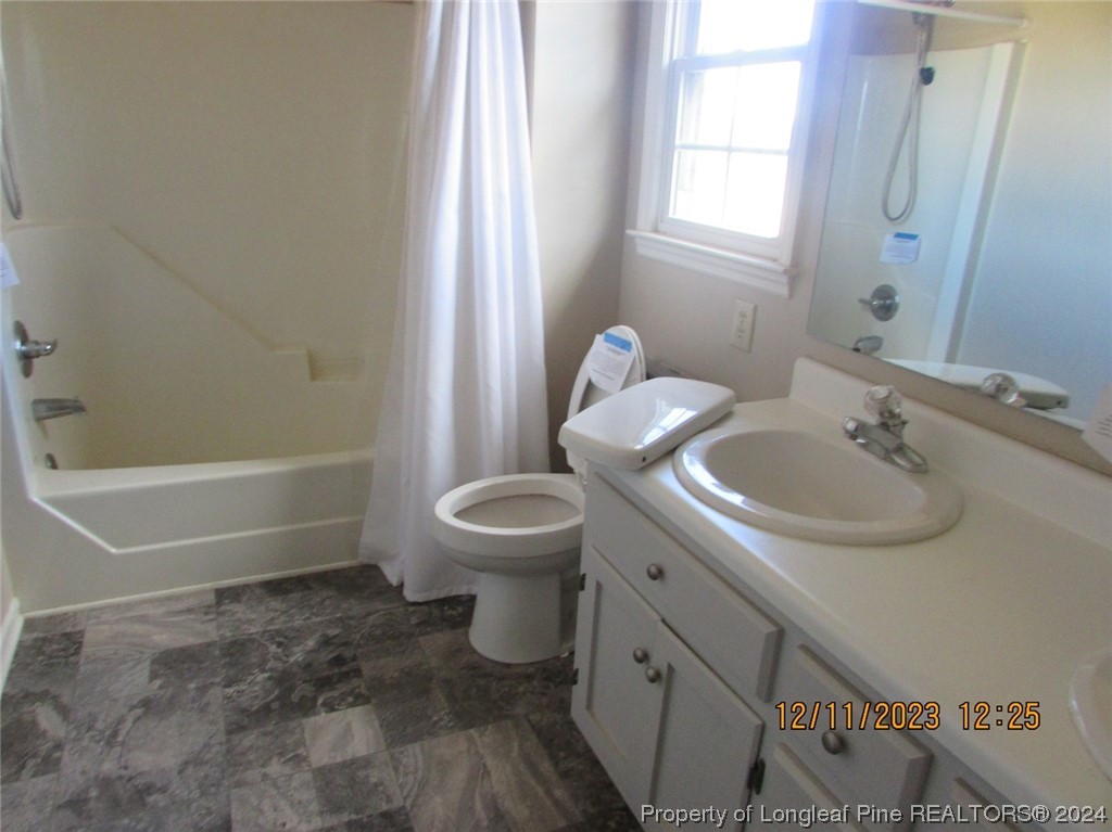 8850 Timothy Road Dunn, NC 28334 - Photo 8 of 15 a bathroom with a sink toilet and shower