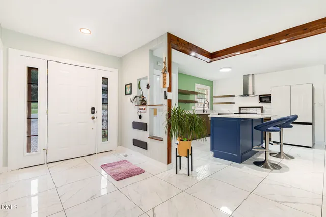 a view of a dining room with furniture and a potted plant
