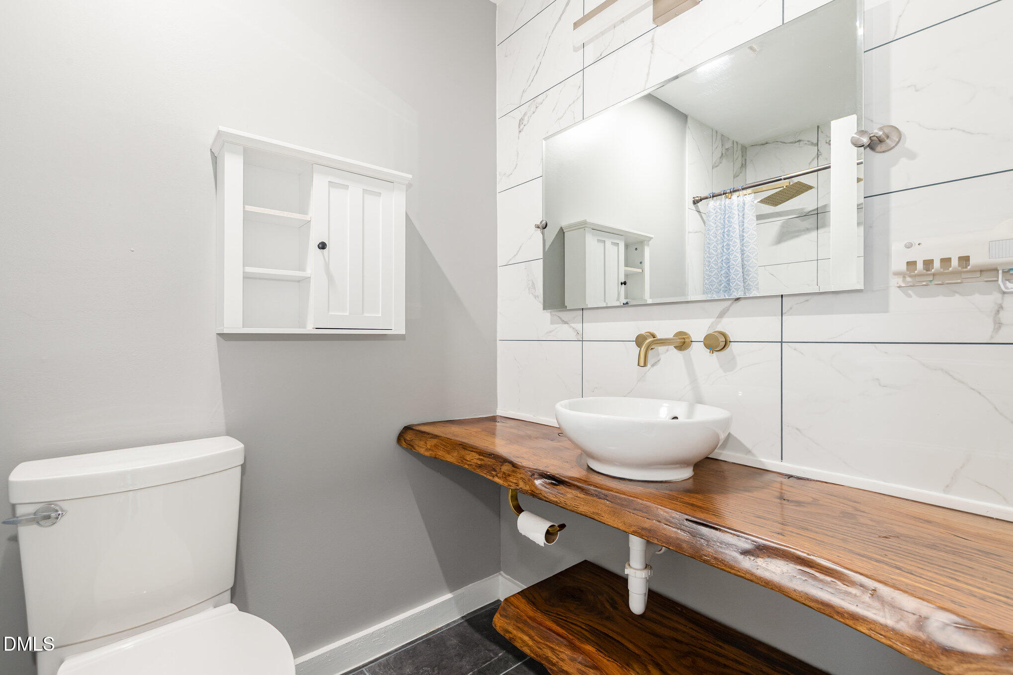 5333 Olive Road Raleigh, NC 27606 - Photo 16 of 21 a bathroom with a toilet a sink and mirror