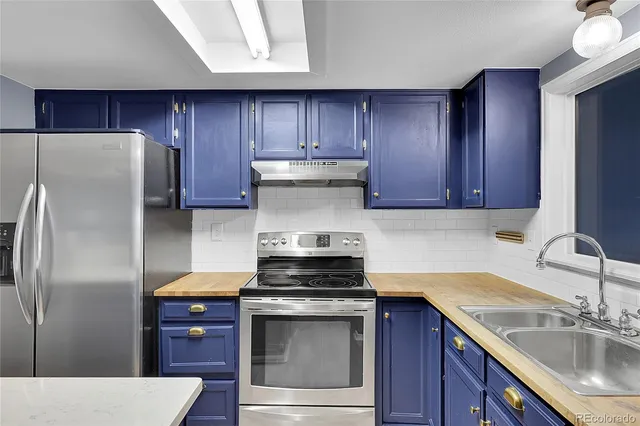 a kitchen with a stove sink and refrigerator