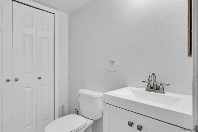 a bathroom with a toilet a sink and mirror