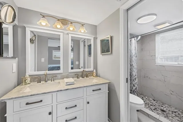 a bathroom with a shower curtain and a toilet