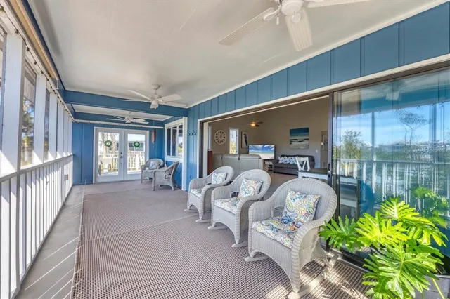 a balcony with furniture and a potted plant