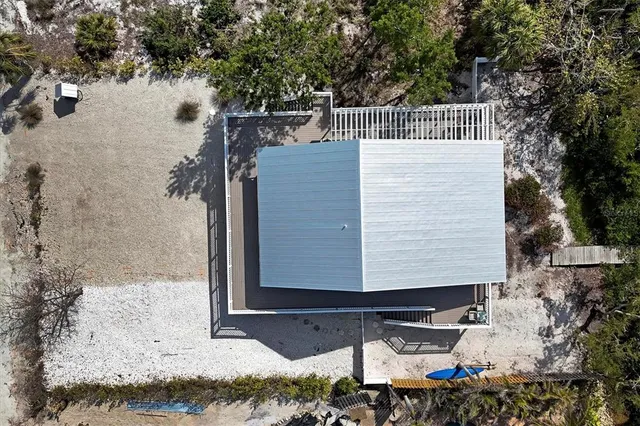 an aerial view of a city with ocean view in back