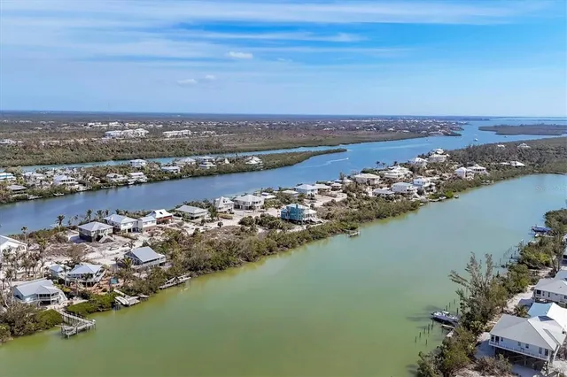 an aerial view of a houses with ocean view