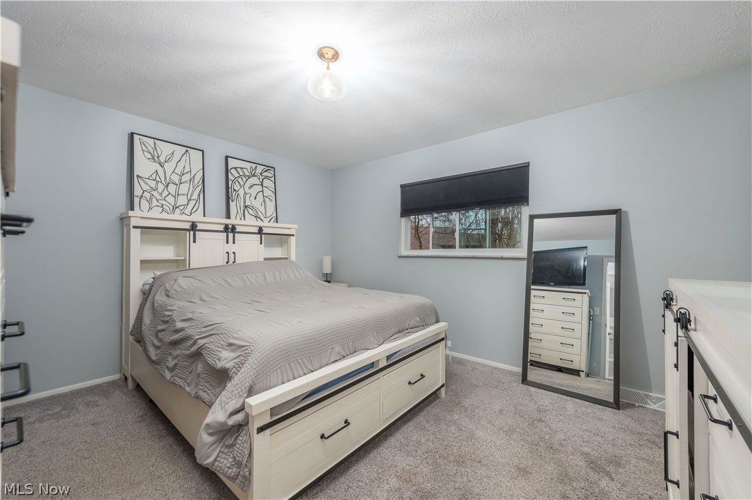 22900 Mastick Road Fairview Park, OH 44126 - Photo 19 of 50 Bedroom featuring light carpet and a textured ceiling