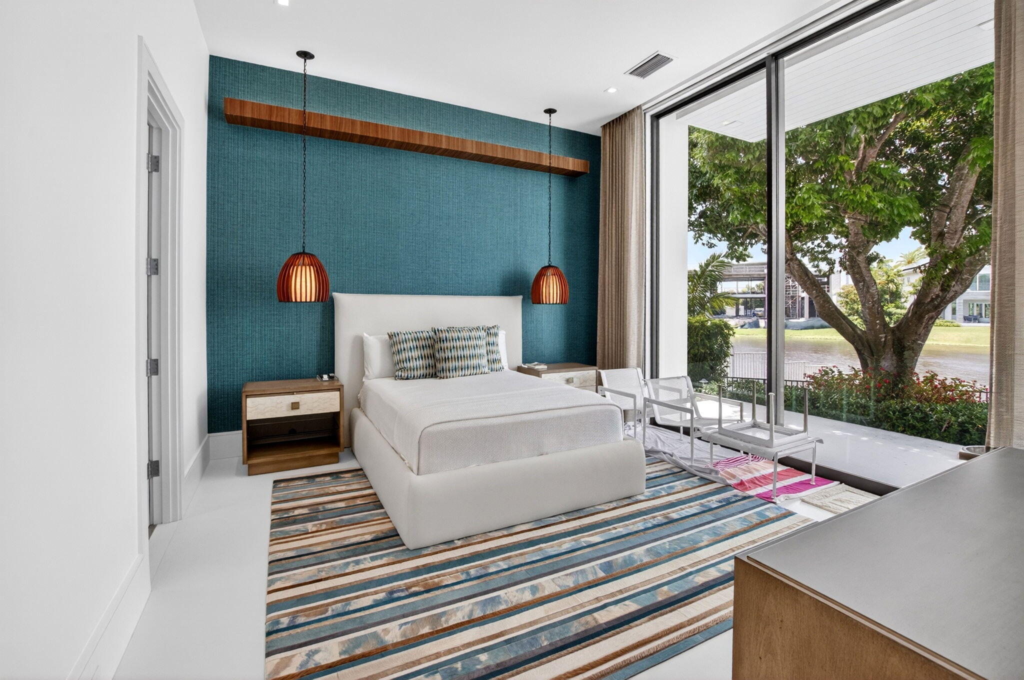 6960 Lake Estates Court Boca Raton, FL 33496 - Photo 27 of 58 a bedroom with a bed and a large window