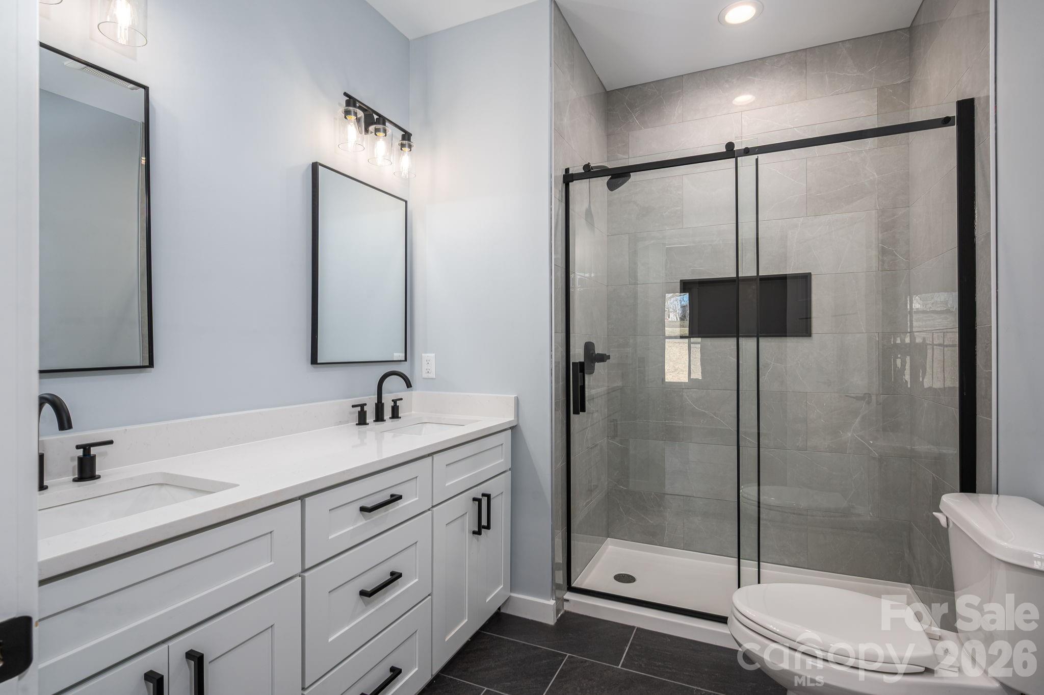1161 13th Street Southwest Hickory, NC 28602 - Photo 17 of 27 a bathroom with a double vanity sink toilet and shower