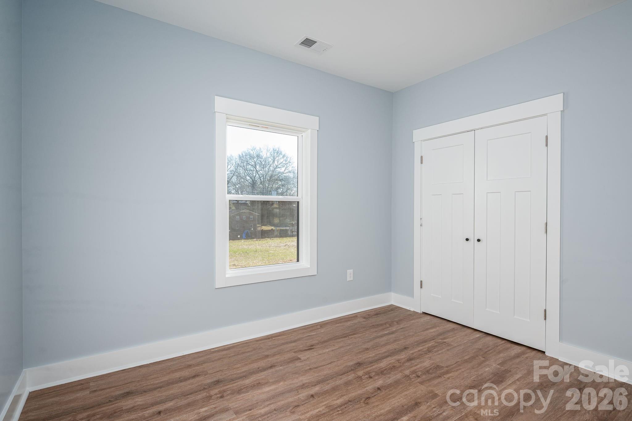 1161 13th Street Southwest Hickory, NC 28602 - Photo 18 of 27 an empty room with wooden floor and windows