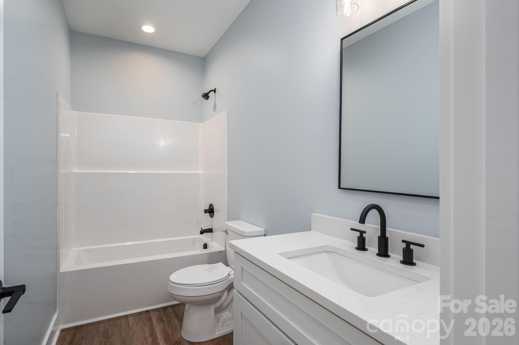 1161 13th Street Southwest Hickory, NC 28602 - Photo 19 of 27 a bathroom with a sink a toilet and shower