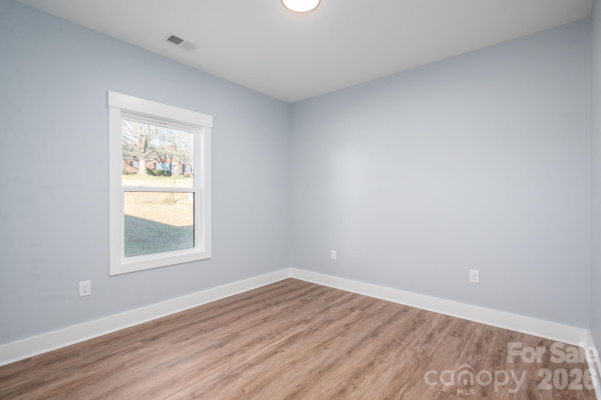 1161 13th Street Southwest Hickory, NC 28602 - Photo 20 of 27 wooden floor in an empty room with a window